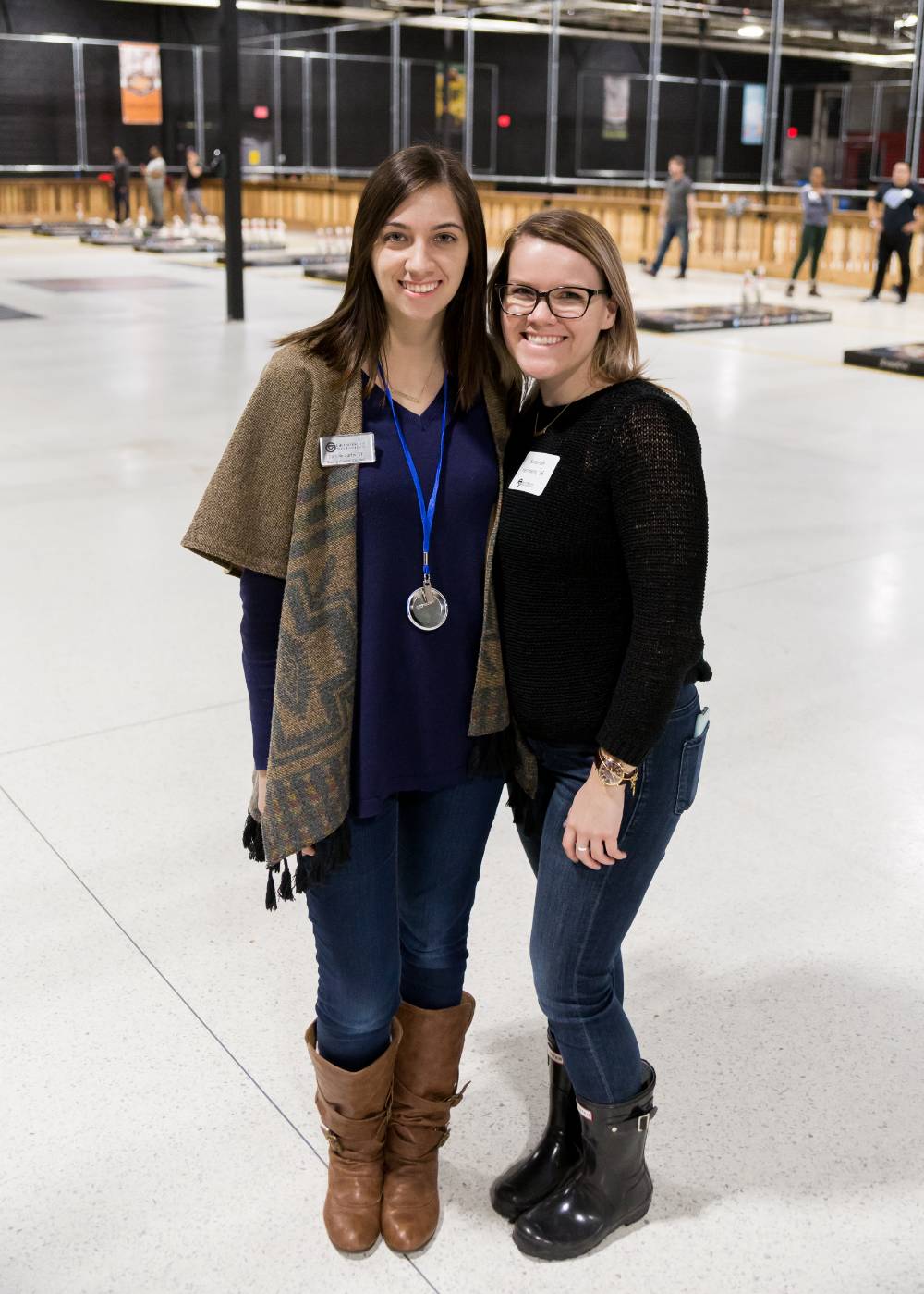 Two alumnae pose for a photo together at the Fowling Fun Event
